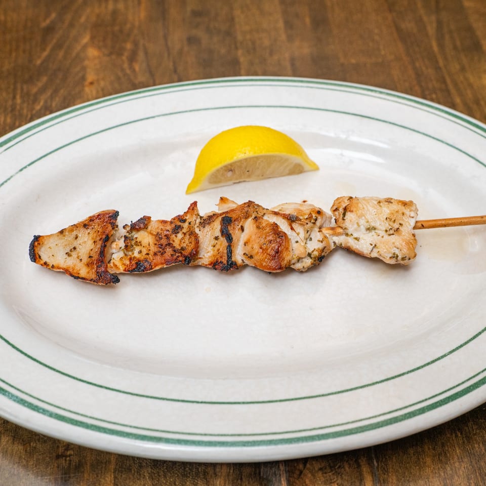 Chicken souvlaki skewer with lemon.